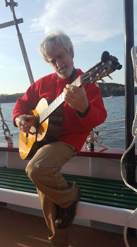 John Tercyak playing a guitar.